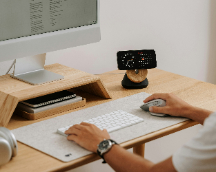 Designer working at a desk with a monitor and keyboard