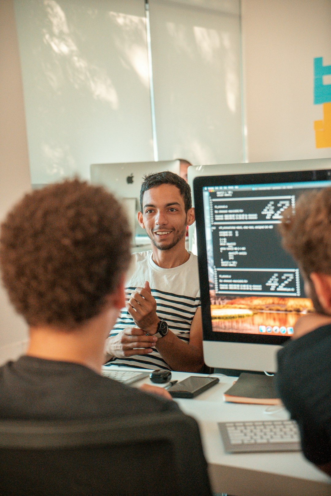 Team reviewing product work together at a monitor