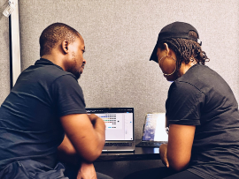 Team members collaborating over a laptop